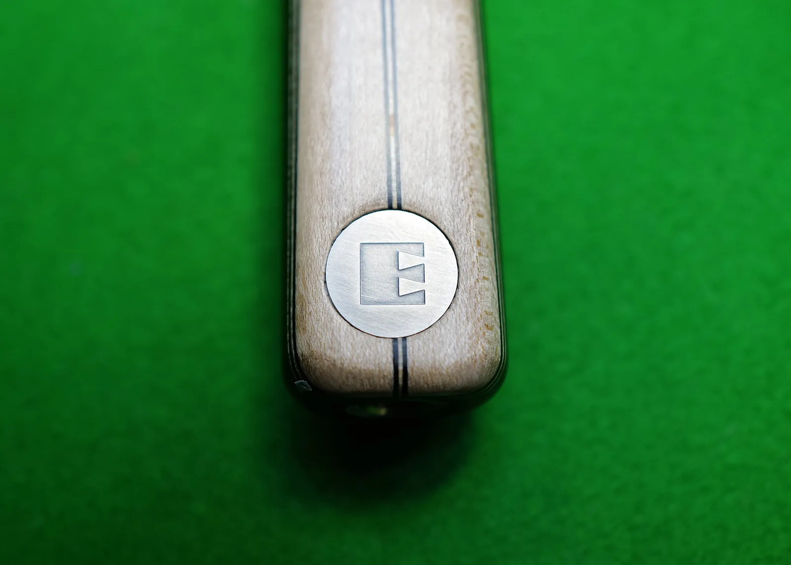 By rotating the symbol 90 degrees, the M monogram turns into an E, also serving as a symbol for Martyn's professional snooker cues produced under his own name, Everitt.